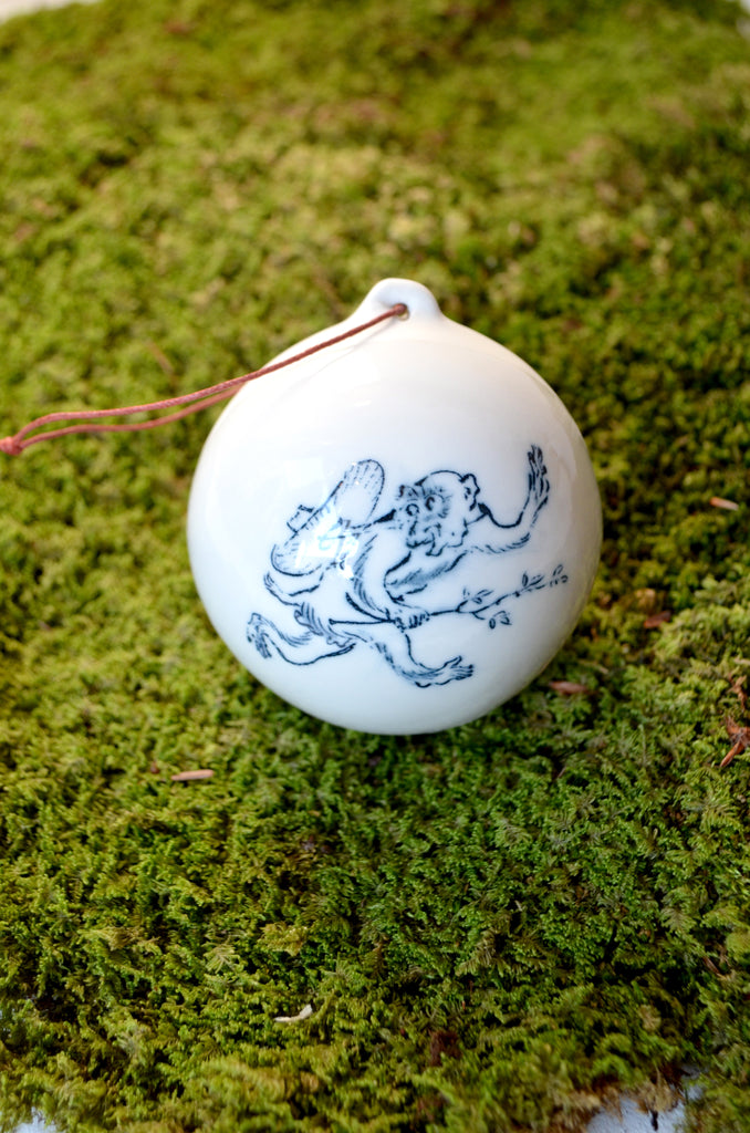 Porcelain Christmas bauble with a monkey motif